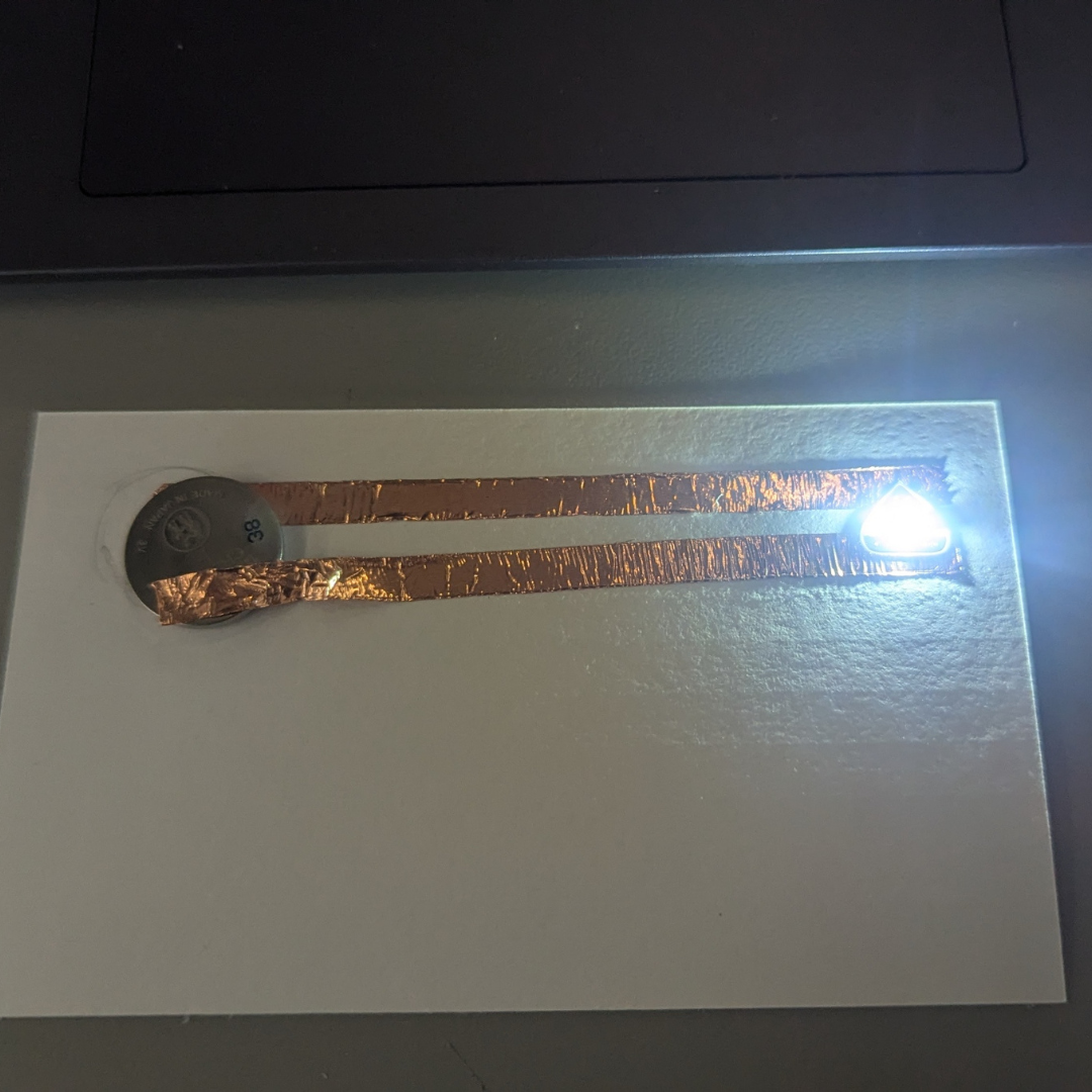 First, I started by following Steve's tutorial and making a simple circuit with copper tape, one LED light, and one low-voltage battery. I also placed a sticker on top of the copper tape. After that, I was excited to experiment, but at the time, I didn't realize how much hassle it would be just to make the LED light flash again.